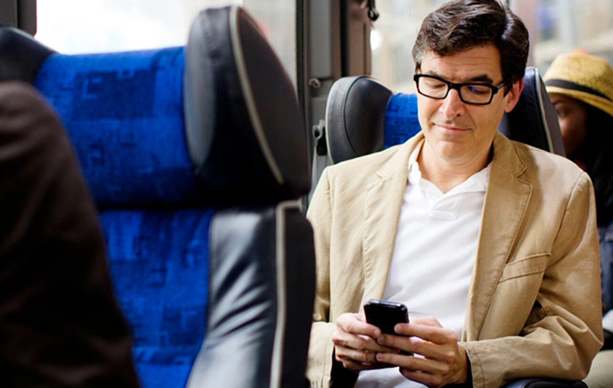 Employee comfortably sitting on a Shuttle Bus